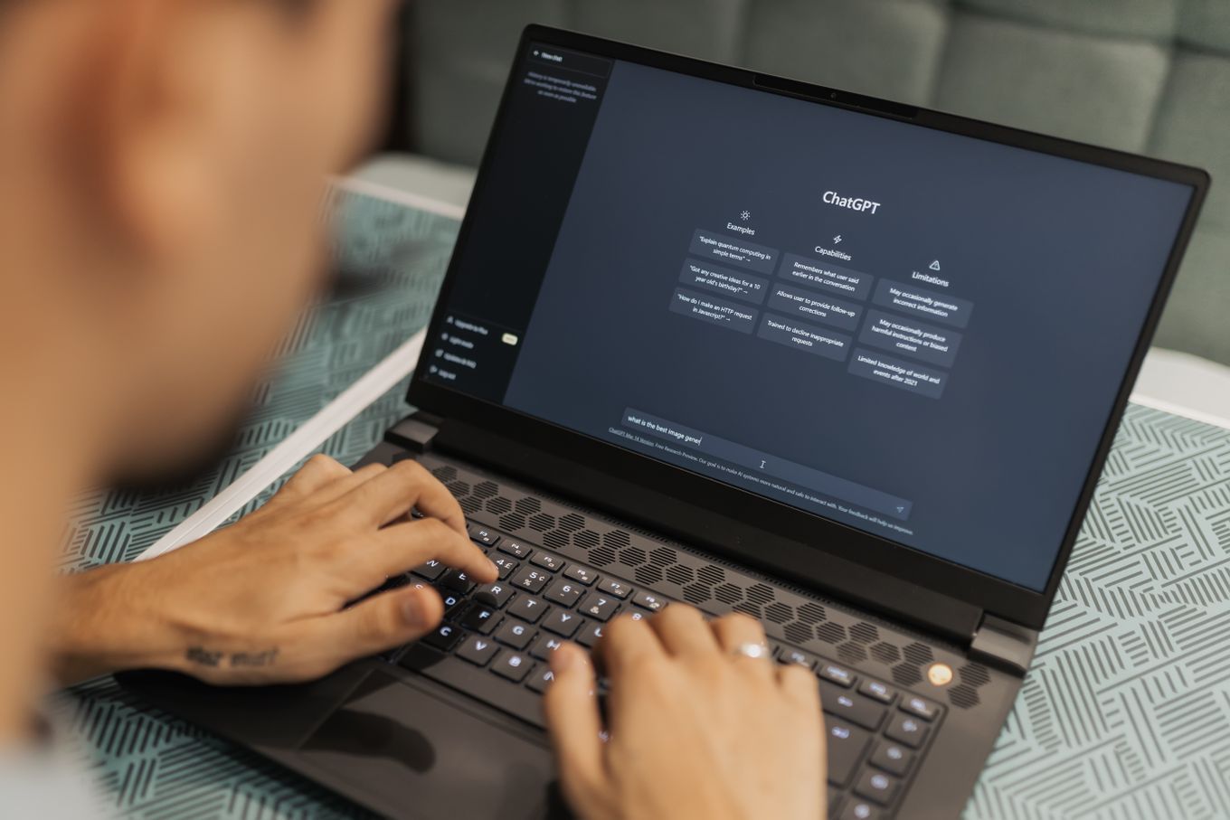 Person typing on a laptop with ChatGPT open on the screen