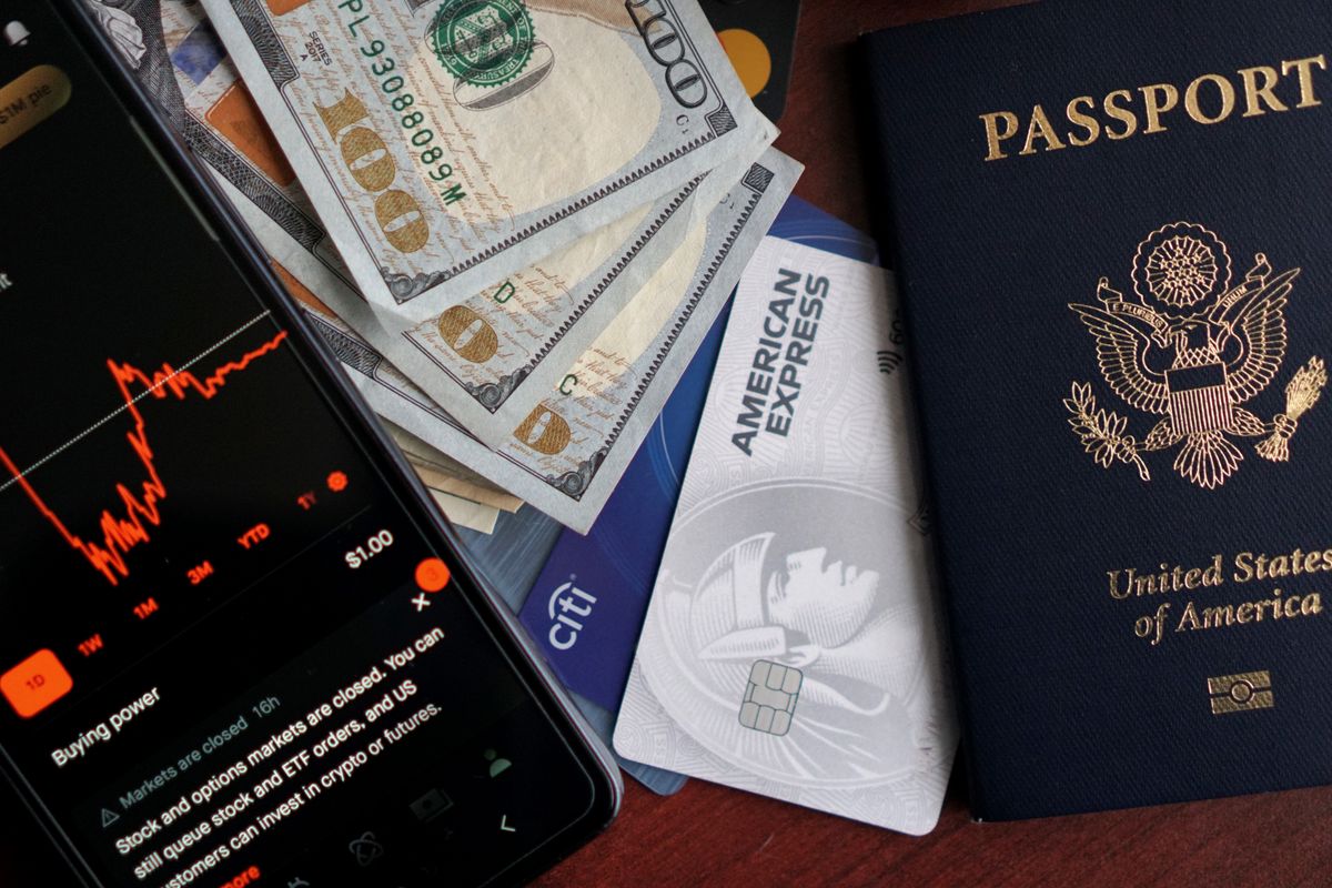 Passport, credit cards, and cash from different countries laid out together