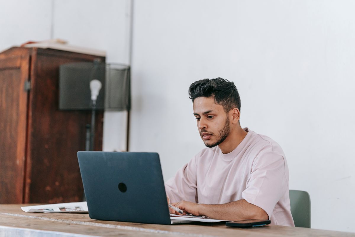 Freelancer working on a laptop at a clean home office desk