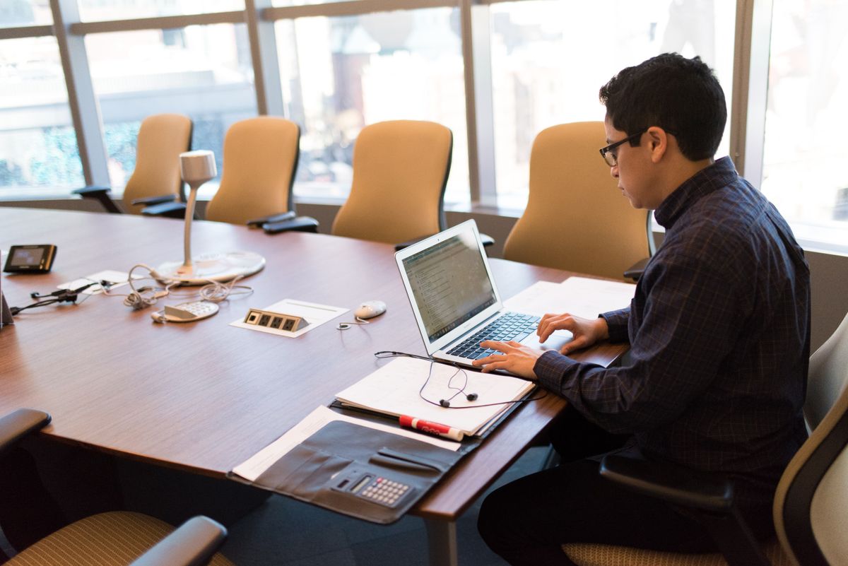 Professional person working on a laptop in a modern office setting